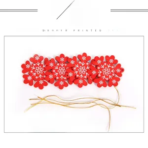 Detail of red Christmas snowflake felt ornaments with gold strings for DIY tree decoration