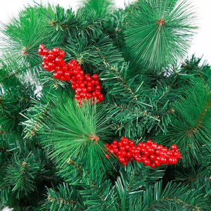 Macro detail of artificial green pine needles and bright red berries for Christmas DIY decor