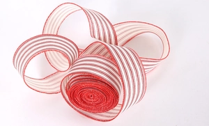 Detail of red and white striped faux linen ribbon with wired edges for Christmas decor