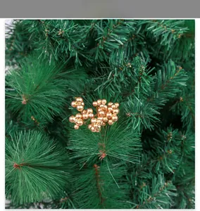Detail shot of artificial Christmas pine branch with golden berry clusters for DIY crafts