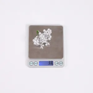 Macro view of berry brooch on scale showing accurate product weight of 3.8 grams