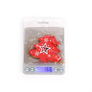 Weight measurement of wooden red Christmas tree ornaments with white snowflake patterns