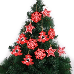 Festive red wooden Christmas tree ornaments with white snowflake patterns and gold strings