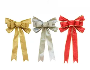 Detailed view of red gold and silver glitter Christmas bows with metallic gold trim edges