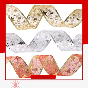 Detail of Christmas ribbons with gold and silver stars, snowflakes and music notes