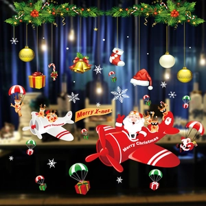 Detailed Christmas window stickers showing Santa flying a plane with colorful snowflakes