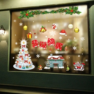 Christmas window decals featuring colorful trees, penguins, and snowflakes on a glass pane