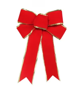 Detail of red velvet Christmas bow with gold metallic edges for tree and party decoration