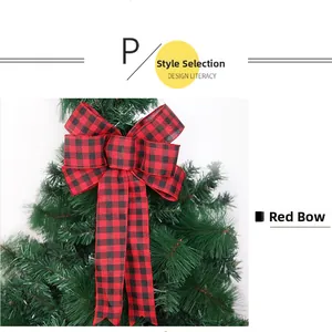 Close-up of a large red and black plaid Christmas bow decorating a festive tree branch