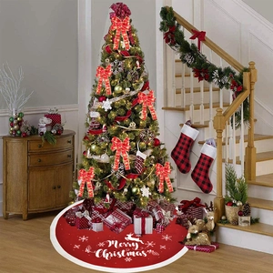 Macro detail of red Merry Christmas tree skirt with white plush trim and reindeer patterns