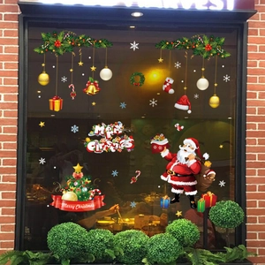 Detailed Christmas window stickers with Santa Claus and festive tree decorations on glass