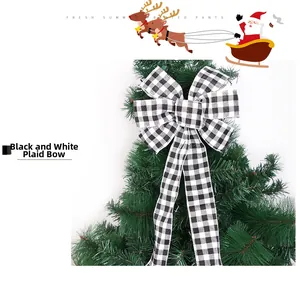 Detail of a large black and white buffalo plaid bow on a Christmas tree branch