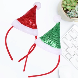 Close-up of red and green sequin mini hats headbands with white plush balls on white desk