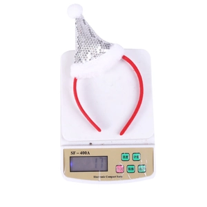 Detail view of a red Christmas headband with silver sequin hat being weighed for its 17g mass