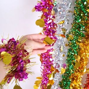 Detail of colorful metallic Christmas tinsel garlands with heart-shaped sequins for parties