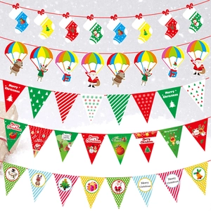 Close-up of Christmas cartoon banners featuring Santa, reindeer, and paper pennant flags