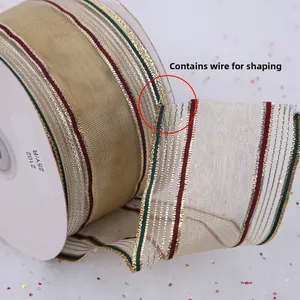 Close-up of flexible wire-edged Christmas ribbon roll in gold and red festive stripes