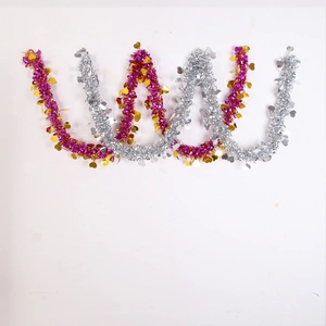 Detail of rose red and silver Christmas tinsel garland with shiny heart sequins