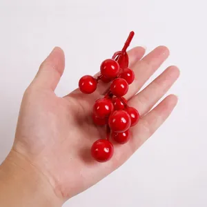 Detail of glossy red artificial berries for Christmas DIY wreaths and tree decorations