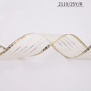 Macro detail of white organza ribbon with gold wired edges for Christmas DIY decoration
