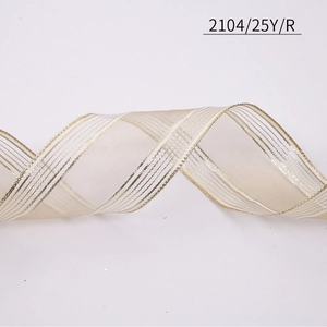 Detail of light gold translucent ribbon with metallic gold parallel stripes for decoration