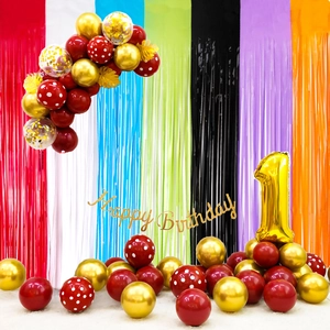 Detail of colorful tassel curtains with balloons and golden number one for party decor