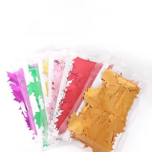 Macro detail of colorful maple leaf shaped foil fringe curtains in vibrant metallic colors