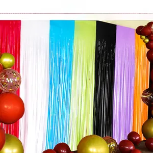 Close-up of multicolor fringe curtains and balloons for birthday party backdrop decoration