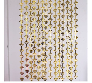 Detail of golden diamond-shaped foil curtain for party background and wall decoration