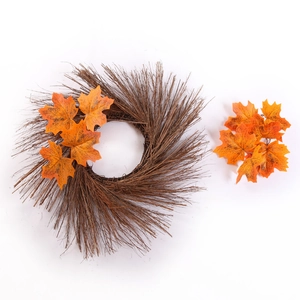 Detail of autumn wreath with brown branches and bright orange maple leaves for fall decor