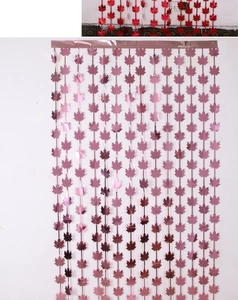 Close-up of metallic pink and red maple leaf foil fringe curtains for Thanksgiving decor