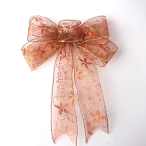 Pink sheer Christmas bow with golden edges and glittering holly leaves for tree decor