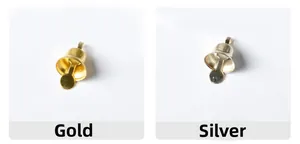 Close-up detail of small gold and silver metal bells for Christmas DIY craft projects