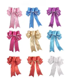 Dettaglio dei fiocchi di Natale glitterati in 9 colori per decorazioni per alberi e regali