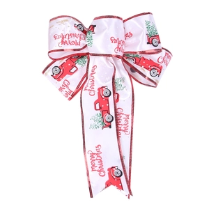 Detailed view of white satin Christmas bow with red vintage truck and tree patterns