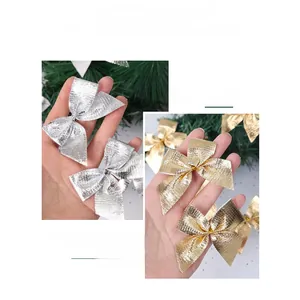 Sparkly gold and silver Christmas bows for tree decoration with glitter fabric texture