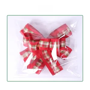 Detail view of red and green plaid Christmas bow in professional polybag packaging