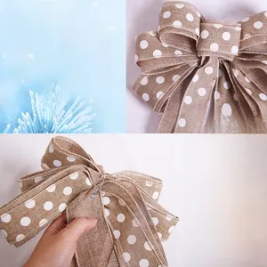 Detail of burlap Christmas bow with white polka dots and flexible wire edges for tree decor