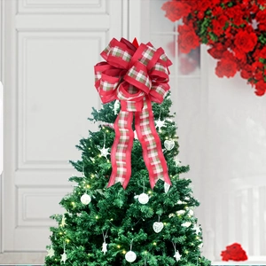 Detailed view of a multi-layer red and plaid festive bow ornament on a Christmas tree
