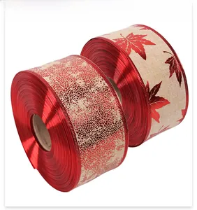 Detail of Christmas ribbons with red marble and maple leaf patterns on burlap texture