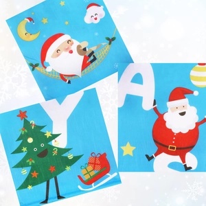 Detail of Christmas festive cloth napkins featuring cartoon Santa and sleigh illustrations