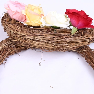 Detail of natural wood grapevine moon wreath base with colorful artificial silk roses