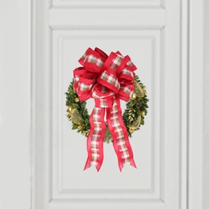 Red and white checkered bow on a green Christmas wreath with pine cones and golden ornaments