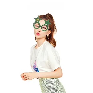 Close-up of sparkling green star-shaped party glasses for festive Christmas celebrations