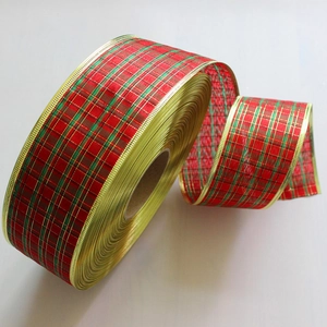 Detail of red and green plaid Christmas ribbon with elegant gold wire edges on a spool