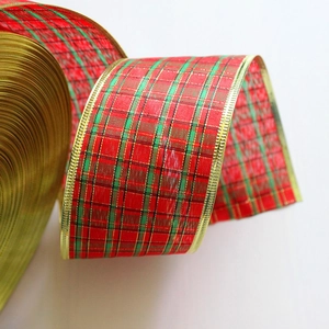 Close-up of Scottish tartan Christmas ribbon with gold metallic edges for festive decor
