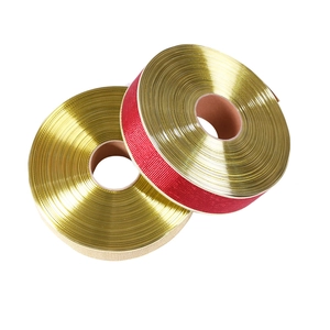 Close-up of metallic gold ribbons on spools for Christmas gift wrapping and DIY decor