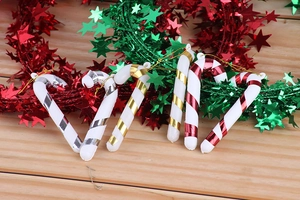 Close-up of 6-piece plastic candy cane ornaments with festive metallic spirals for Christmas trees