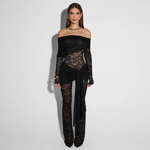 Detailed close-up of high-quality floral lace texture and ribbon tie on black bodysuit