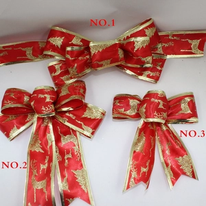 Three red Christmas bows with gold elk and tree patterns in different sizes and styles